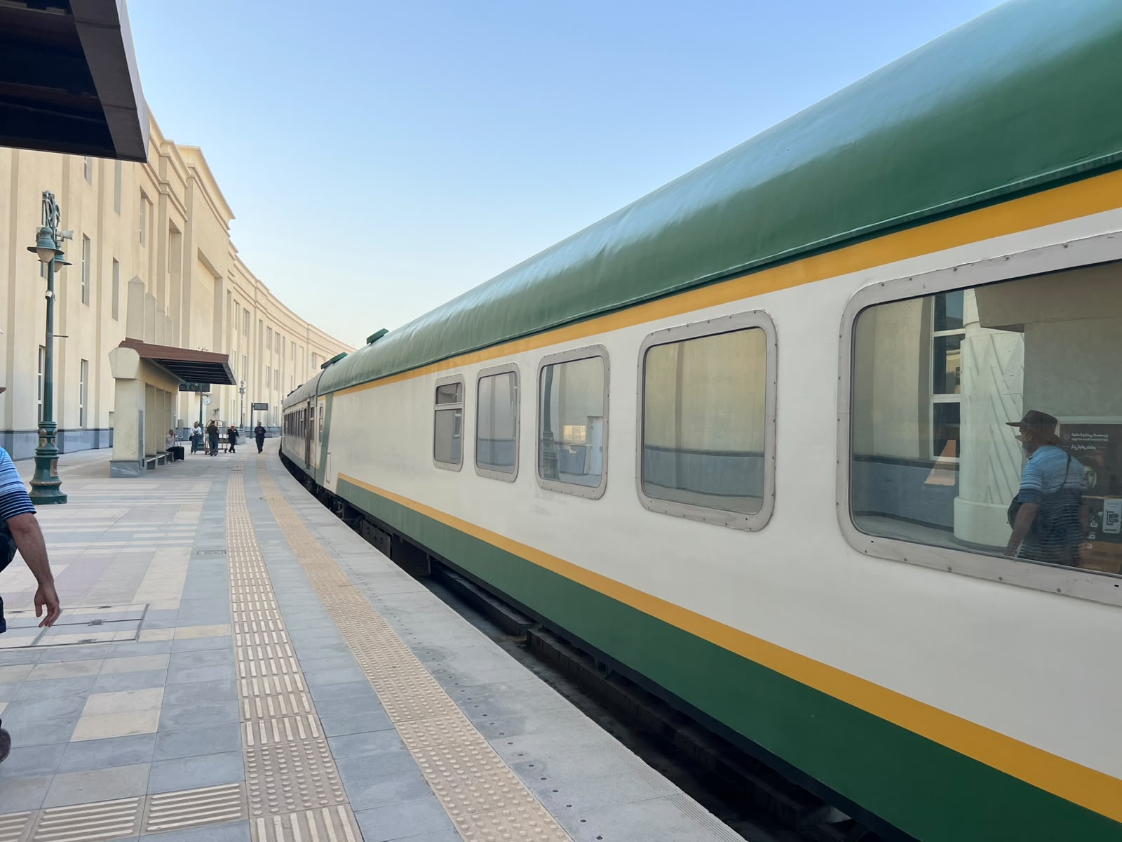 Green and cream sleeper train carriage at an Egyptian station platform