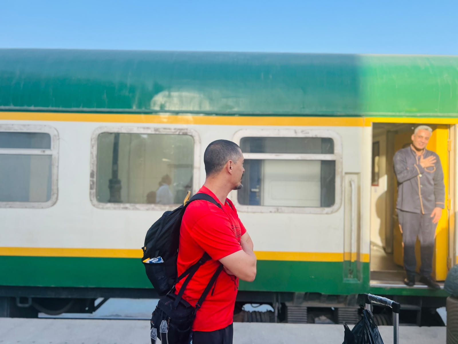Guest waiting on the platform as the sleeper train prepares to depart