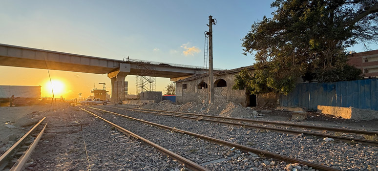 El Alamein station at sunset with new motorway flyover under construction overhead