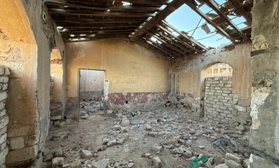 Collapsed roof and exposed rafters inside the historic El Alamein station