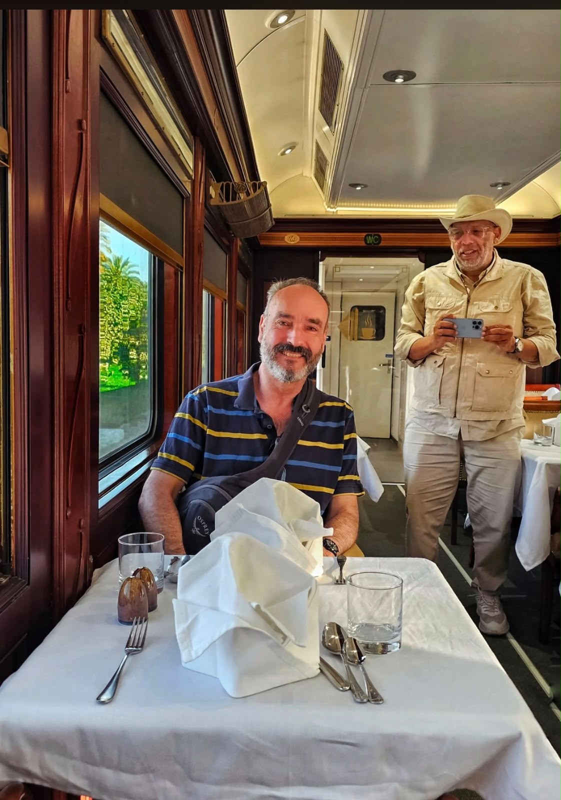 Guest at a laid table in the sleeper train dining car