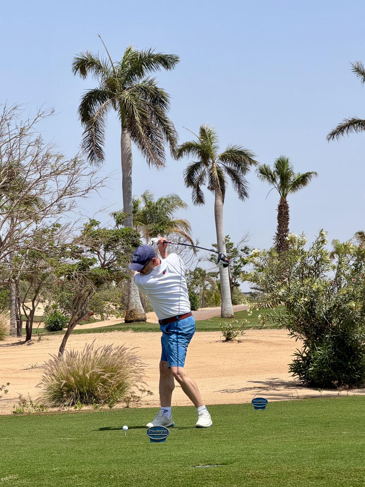 Partner teeing off at The Allegria golf course near Cairo