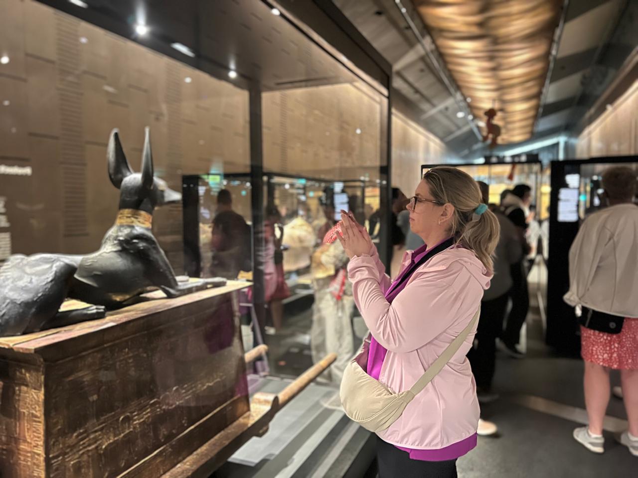 Travel partner photographing the Anubis shrine at the Grand Egyptian Museum