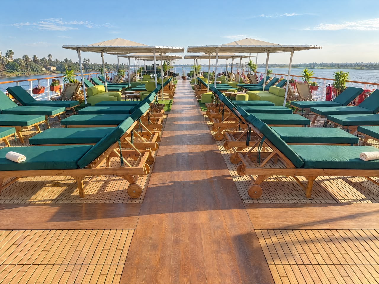 Sundeck with wooden loungers and shaded parasols, representative imagery of Q Nile