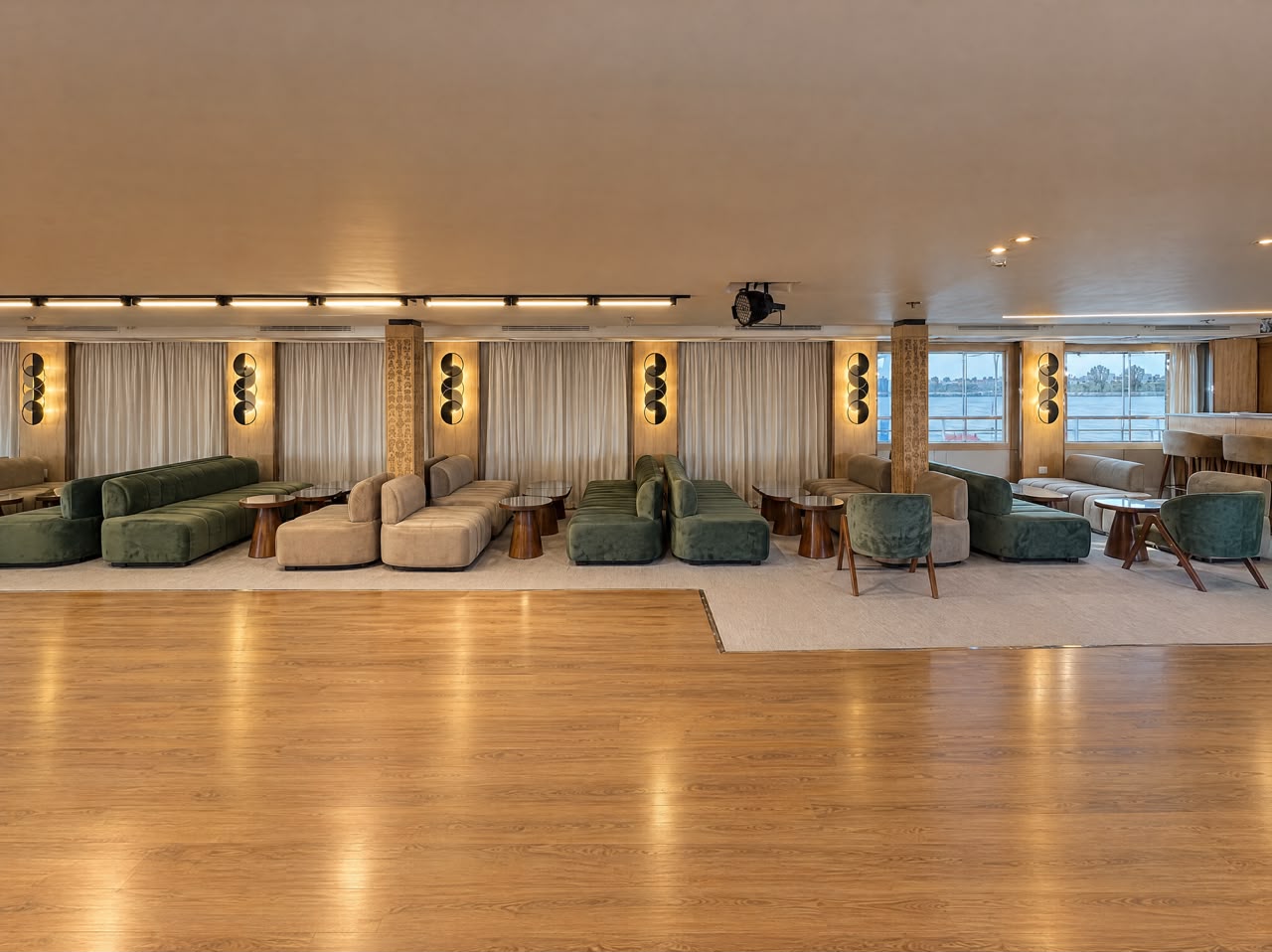 Green velvet sofas and wooden dance floor in the Moletnela lounge