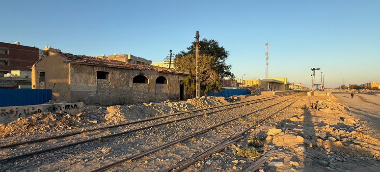 The original El Alamein railway station building in 2026 standing beside active tracks