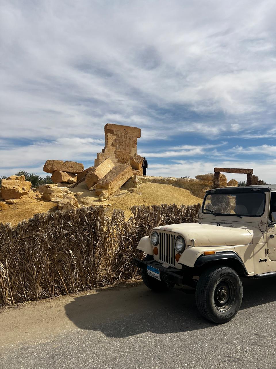 Classic Jeep beside the ruins of the Temple of the Oracle in Siwa Oasis, Egypt