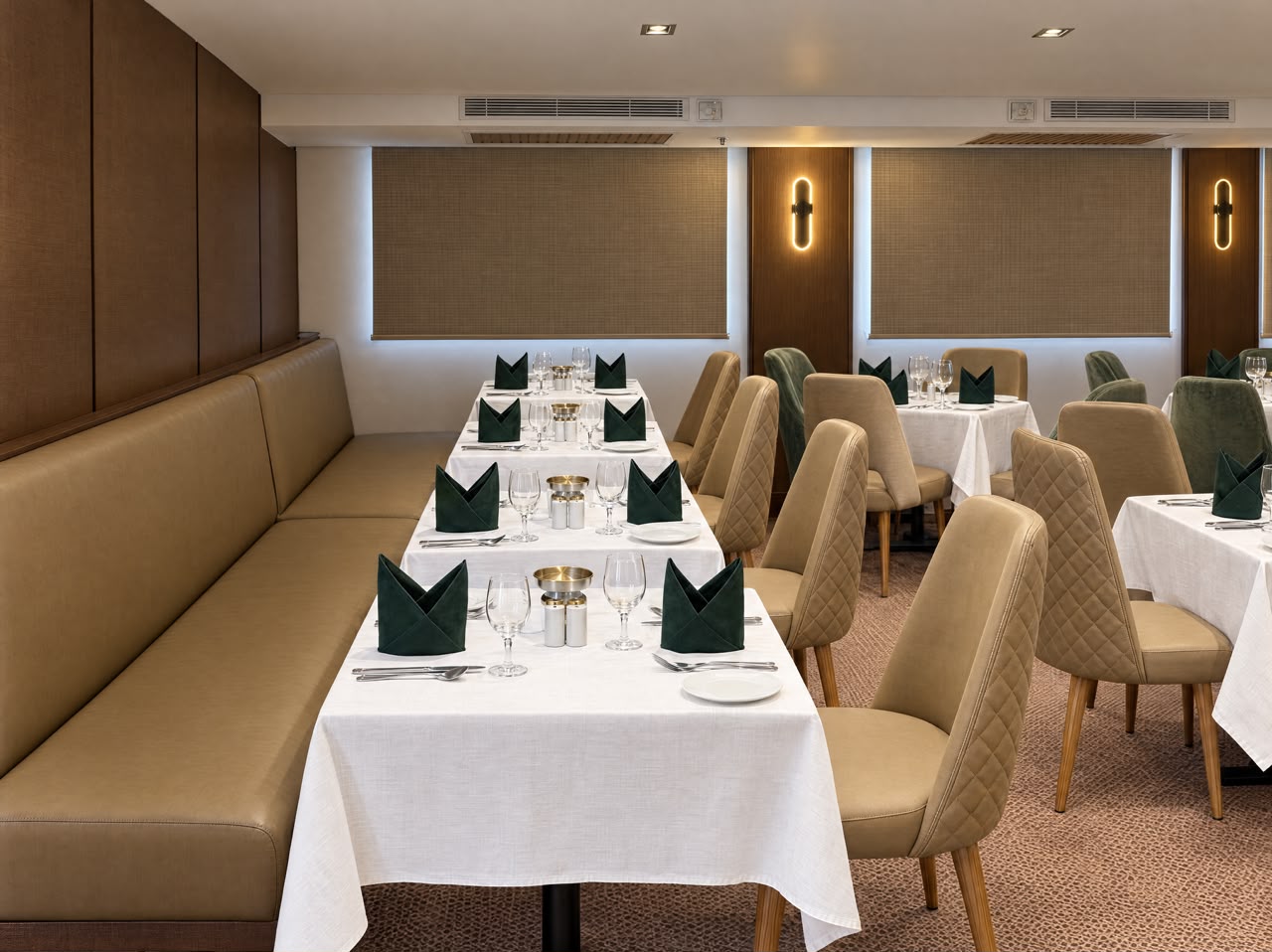 Main restaurant corner seating with green napkins, representative imagery of Q Nile