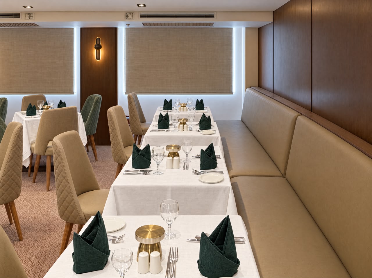 Main restaurant banquette seating with dressed tables, representative imagery of Q Nile
