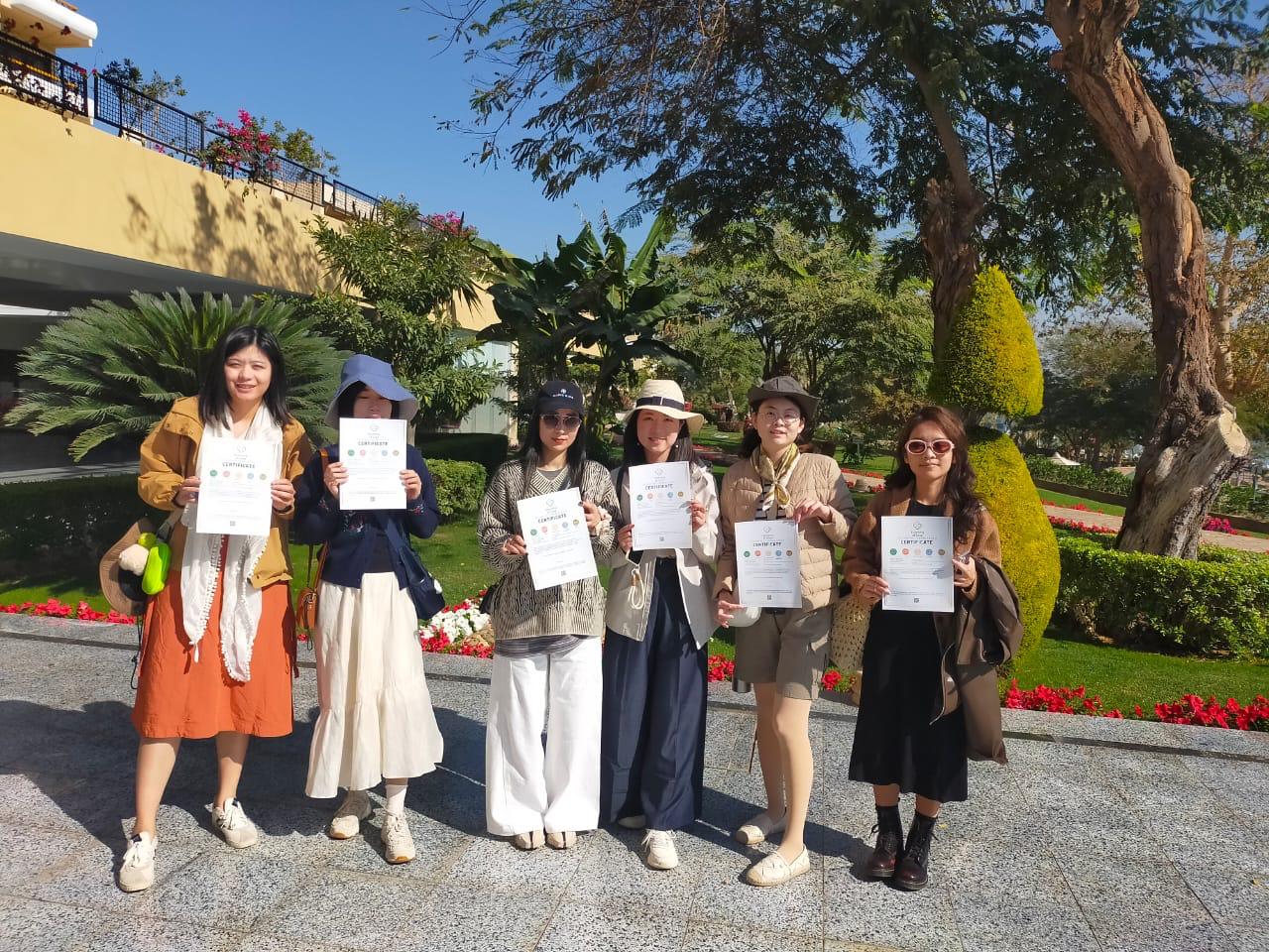 Chinese travellers in Egypt holding Amisol sustainability certificates