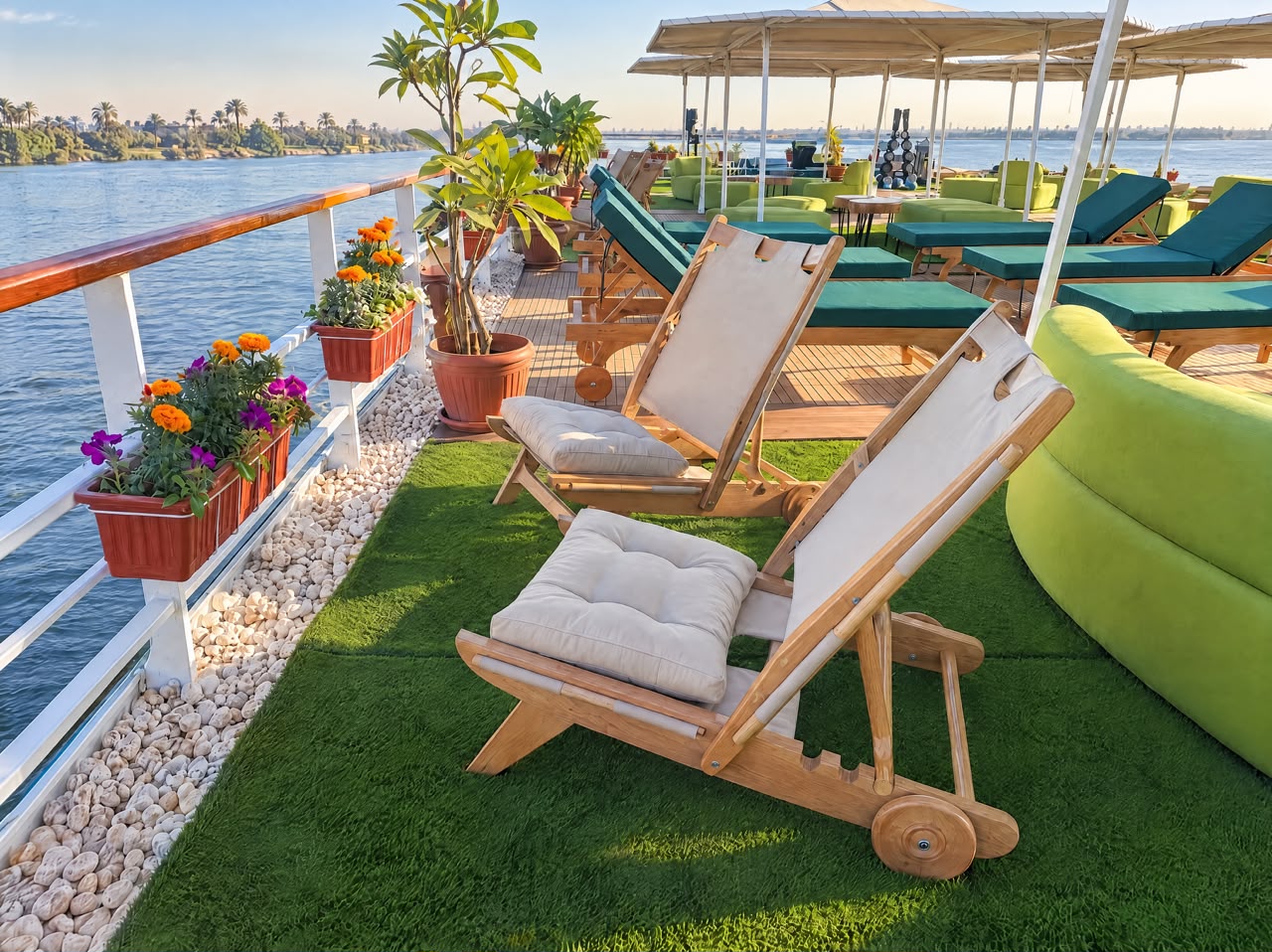 Wooden deck chairs with cushions overlooking the Nile, representative imagery of Q Nile