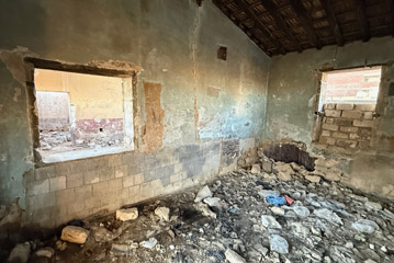 Interior of El Alamein station showing bricked-up windows and rubble